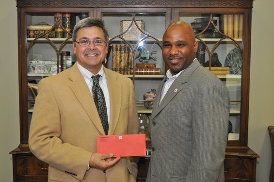 (L to R)  Delta State University National Alumni Association President George Bassi, of Laurel, accepts the corporate sponsorship check from Cleveland State Farm Agent Patrick Davis.